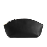 Black Total Eclipse | Spacious leather makeup bag with curved seams and top zipper