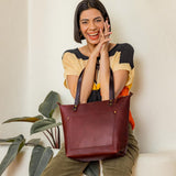 Cognac Zipper | Model holding large zipper leather tote bag with sturdy bridle handles and front pocket