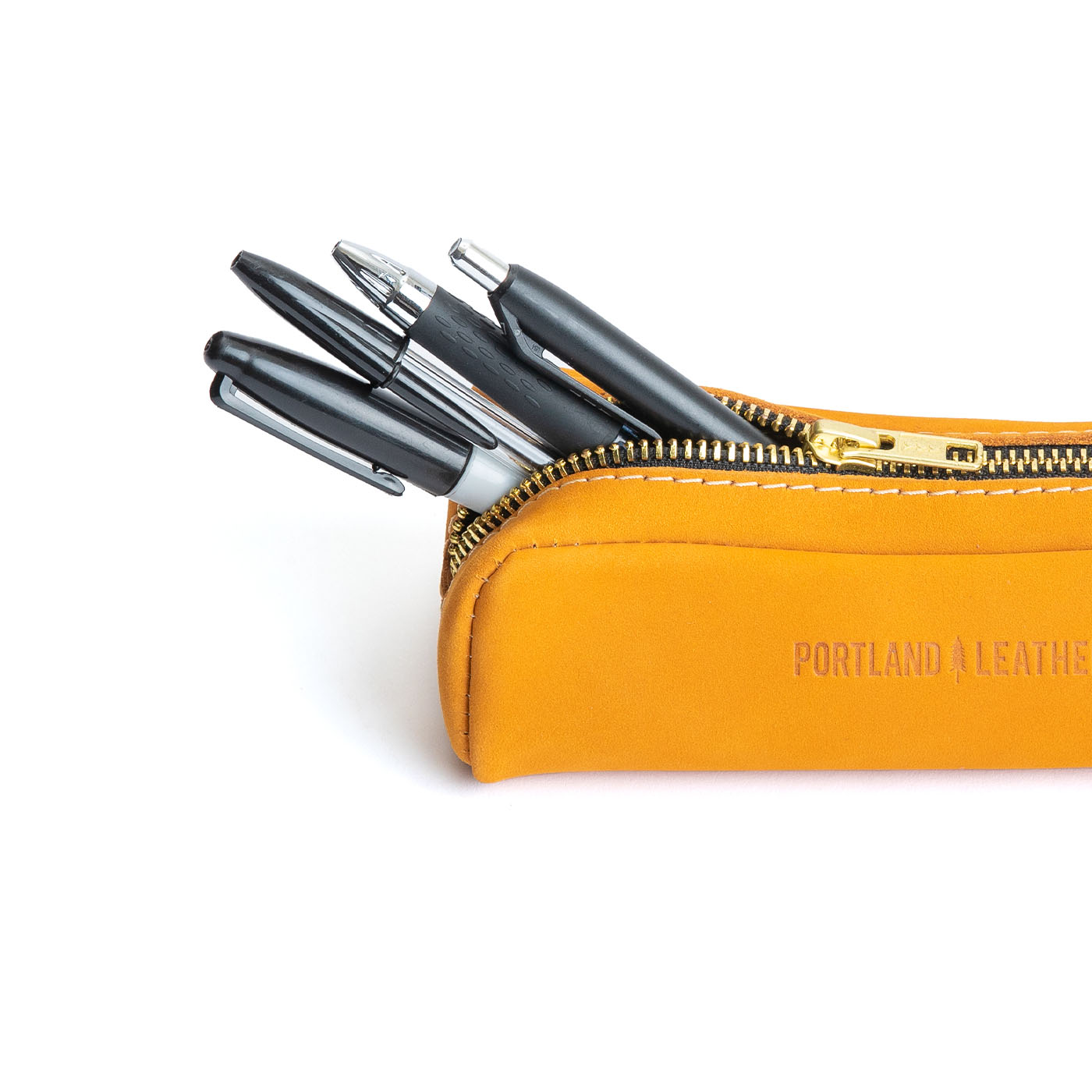 All Color: Turmeric | Leather pouch with a curved top and zipper