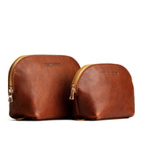 Nutmeg | Size comparison shot of leather makeup bags with curved top zipper and flat bottom