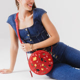 Folklore Ruby Large | Circle shaped crossbody bag with embroidered flower design