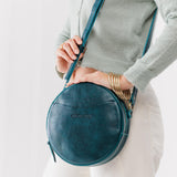 Lagoon Large | Model holding circle shaped crossbody bag with top zipper