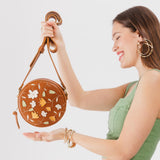 Folklore Honey Small | Circle shaped crossbody bag with embroidered flower design