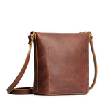 Nutmeg | Back of rectangular side bag with curved front pocket and metal tree shaped badge