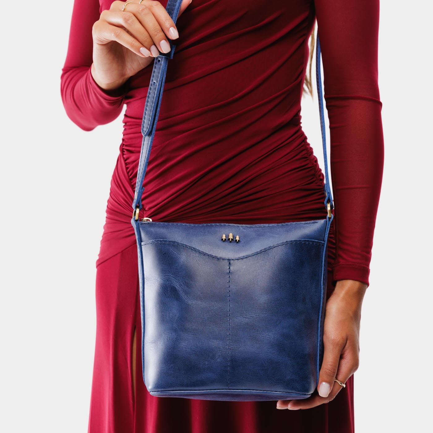 Cowboy Blue | Model wearing rectangular side bag with curved front pocket and metal tree shaped badge