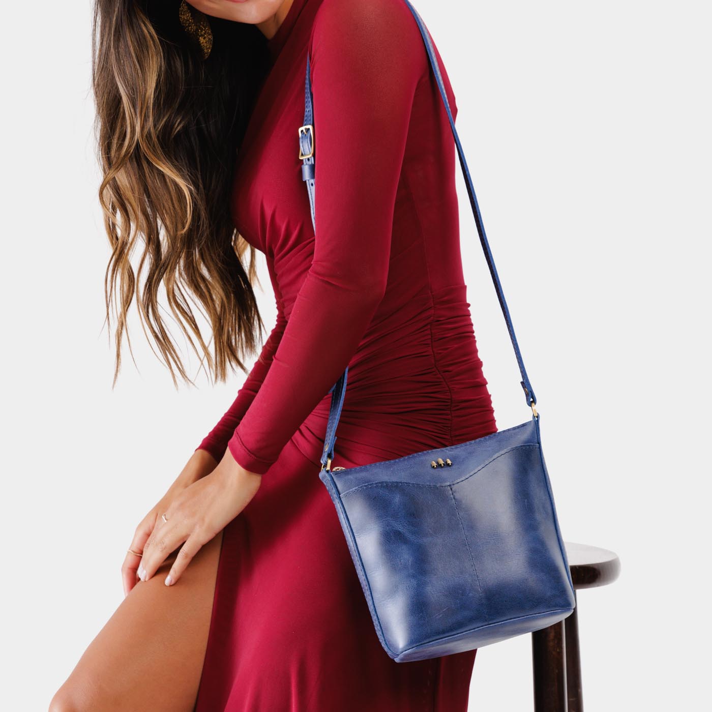 Cowboy Blue | Model wearing rectangular side bag with curved front pocket and metal tree shaped badge