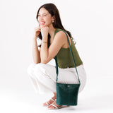 Forest Green | Model wearing rectangular side bag with curved front pocket and metal tree shaped badge