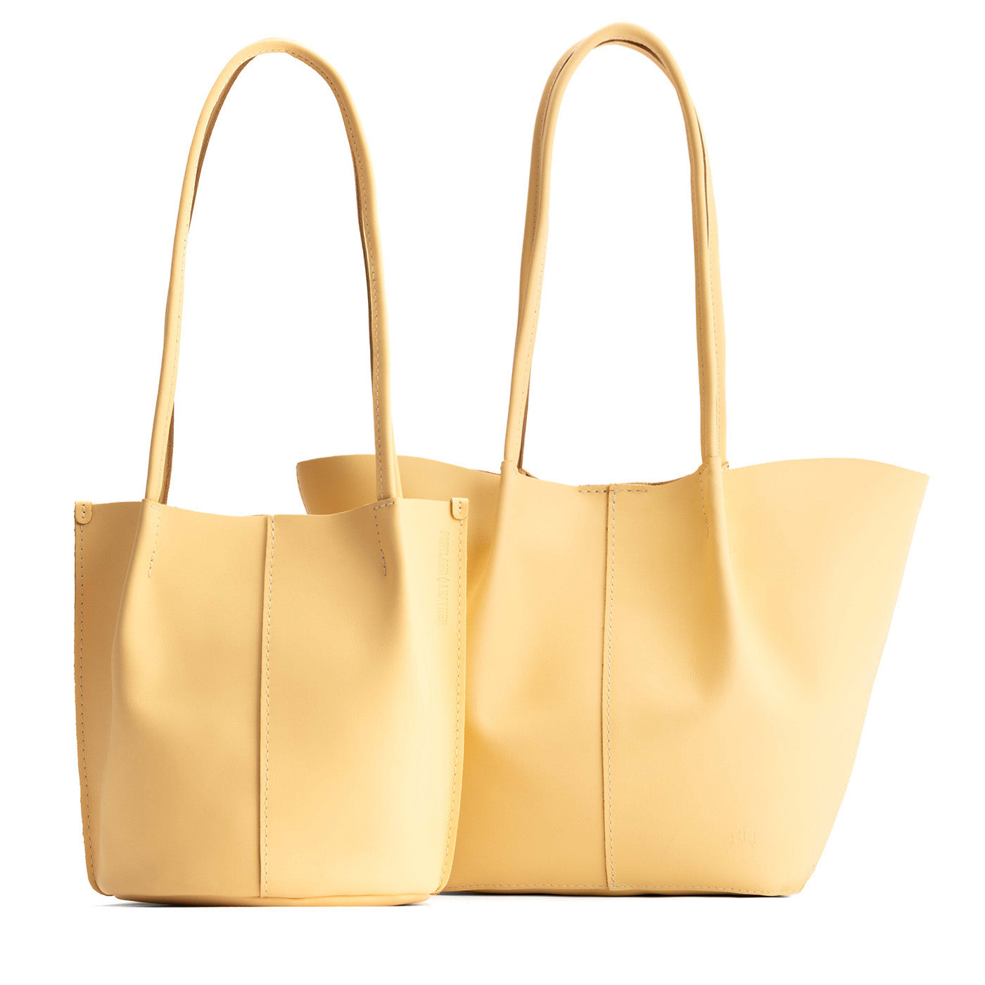 Vanilla | Size comparison of classic and large bucket shaped tote bags with matching leather handles