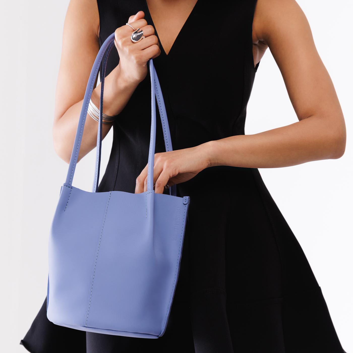 Jacaranda*Classic | Model wearing petite bucket shaped tote bag with matching leather handles