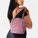 Kyoto | Model holding petite bucket shaped tote bag with matching leather handles