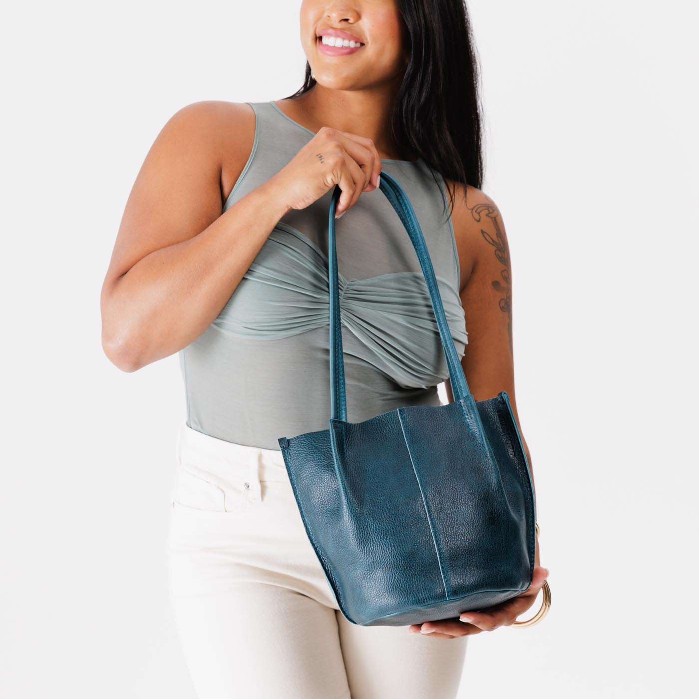 Lagoon*Classic | Model holding petite bucket shaped tote bag with matching leather handles