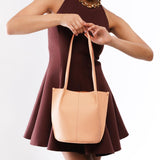 Mamey Classic | Model wearing petite bucket shaped tote bag with matching leather handles