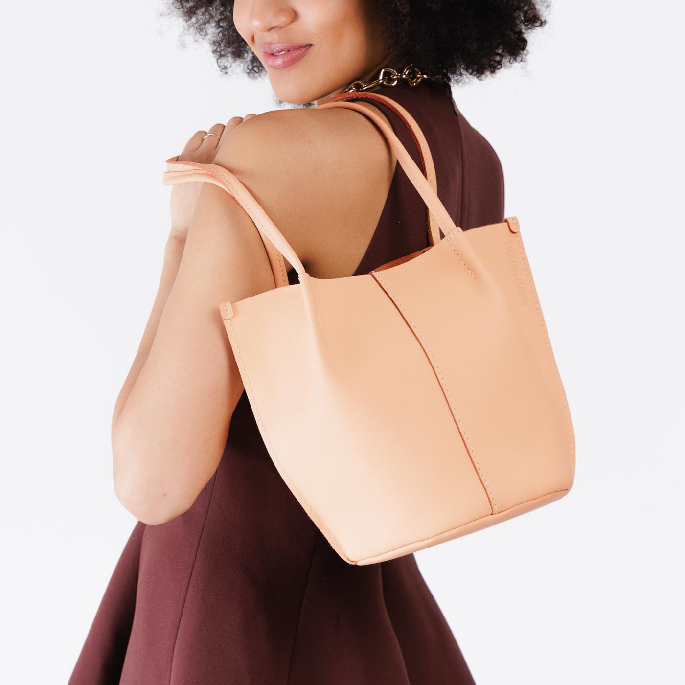 Mamey*Classic | Model wearing petite bucket shaped tote bag with matching leather handles