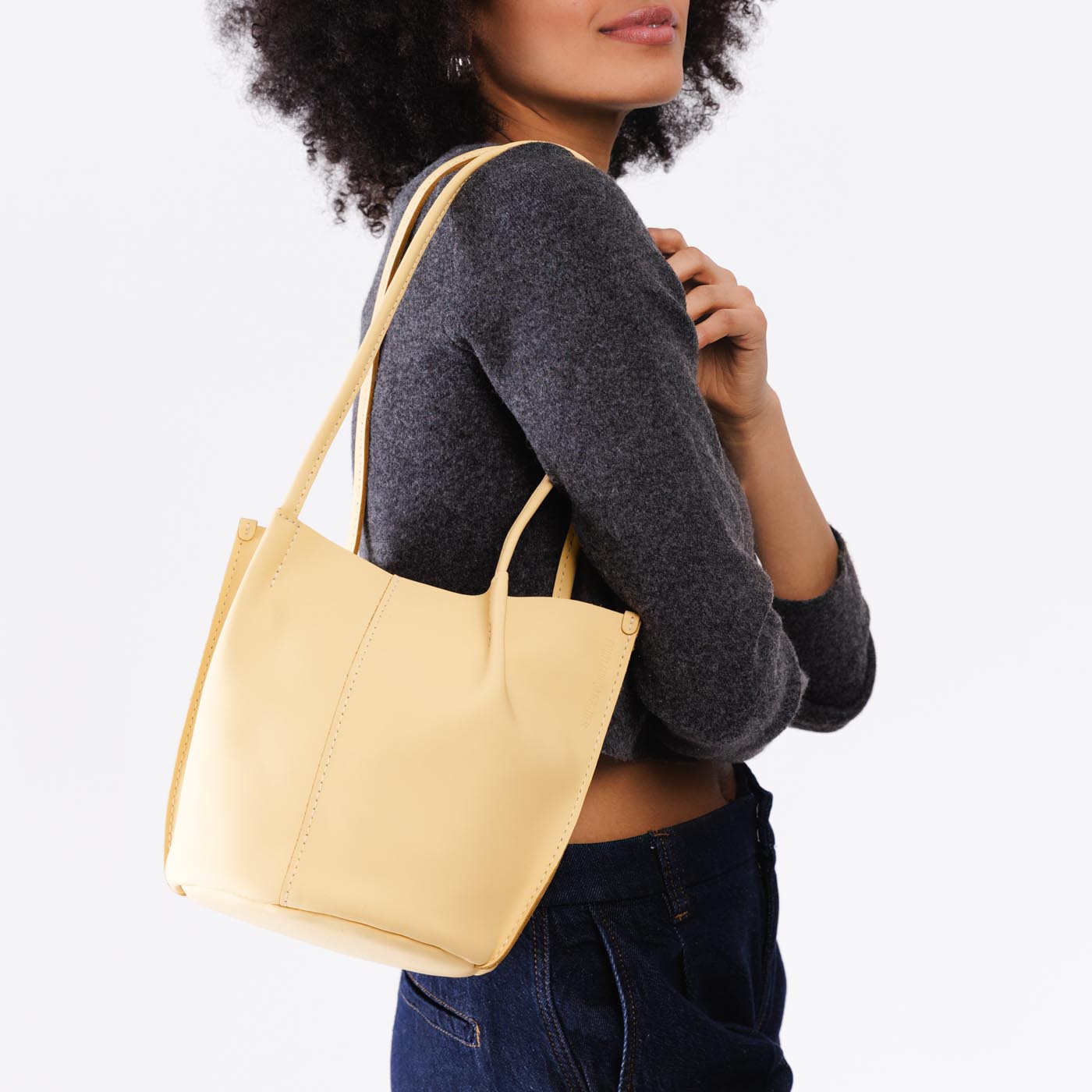 Vanilla*Classic | Model wearing petite bucket shaped tote bag with matching leather handles