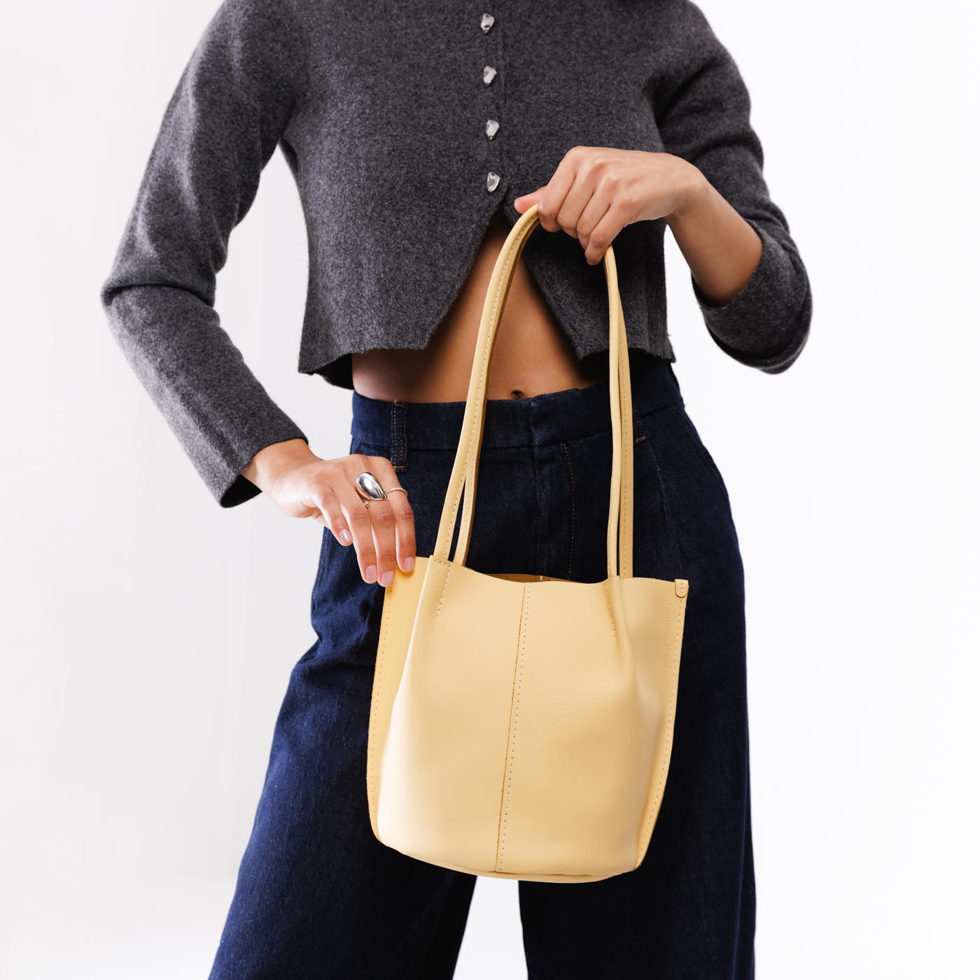 Vanilla*Classic | Model wearing petite bucket shaped tote bag with matching leather handles