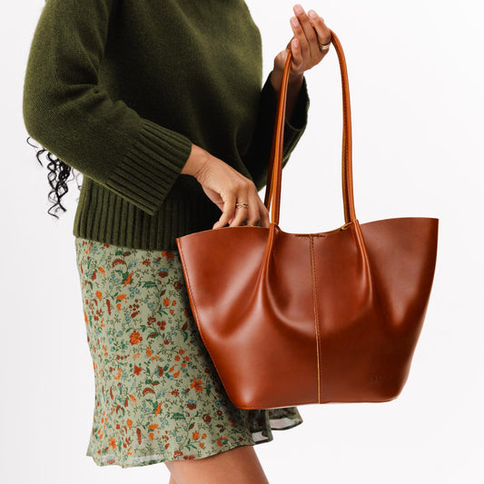 Madrone*Large | Model holding wide bucket shaped tote bag with matching leather handles