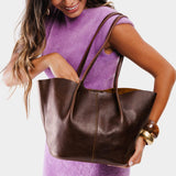 Coldbrew Large | Model holding wide bucket shaped tote bag with matching leather handles