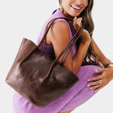 Coldbrew Large | Model holding wide bucket shaped tote bag with matching leather handles