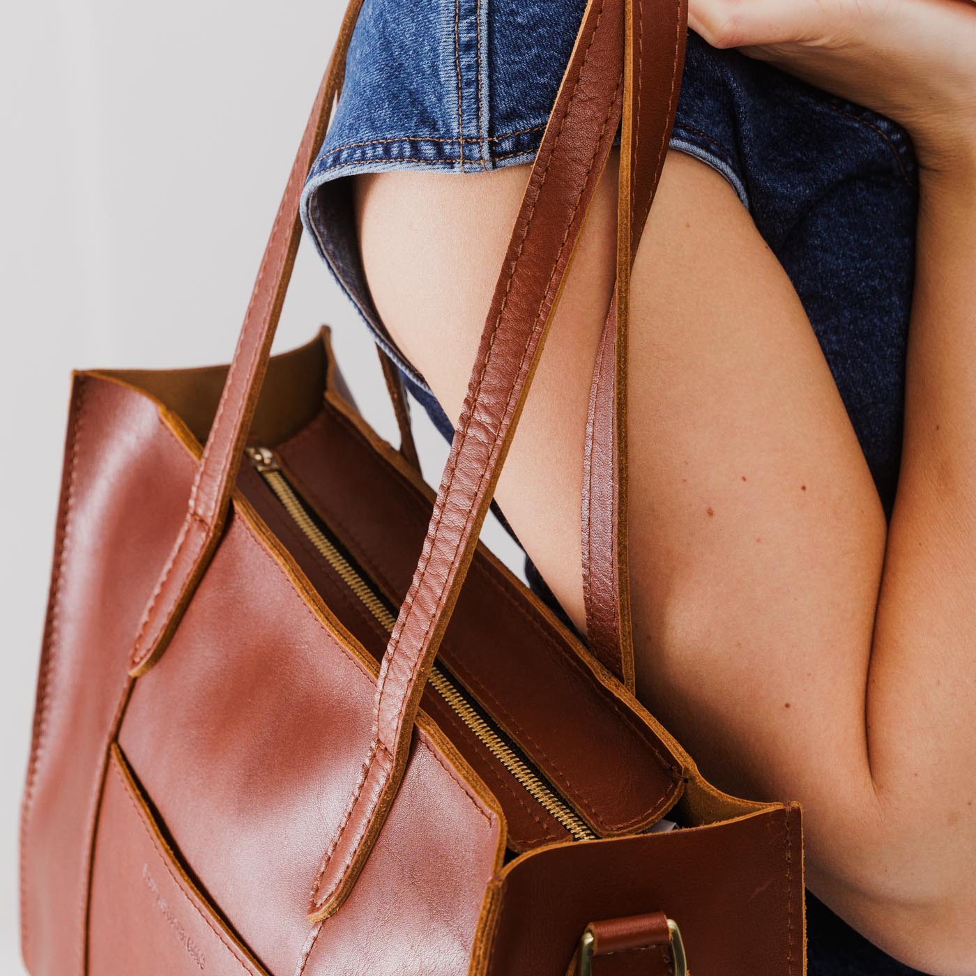 Chestnut*East/West | Structured wide tote bag with overlapping panels and crossbody strap