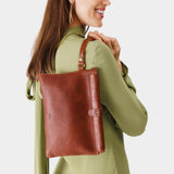 Nutmeg | Model holding rectangular clutch with removable wristlet