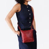 Chili Red | Model wearing small rectangular crossbody purse with top zipper and interior pocket