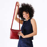 Chili Red | Model wearing small rectangular crossbody purse with top zipper and interior pocket