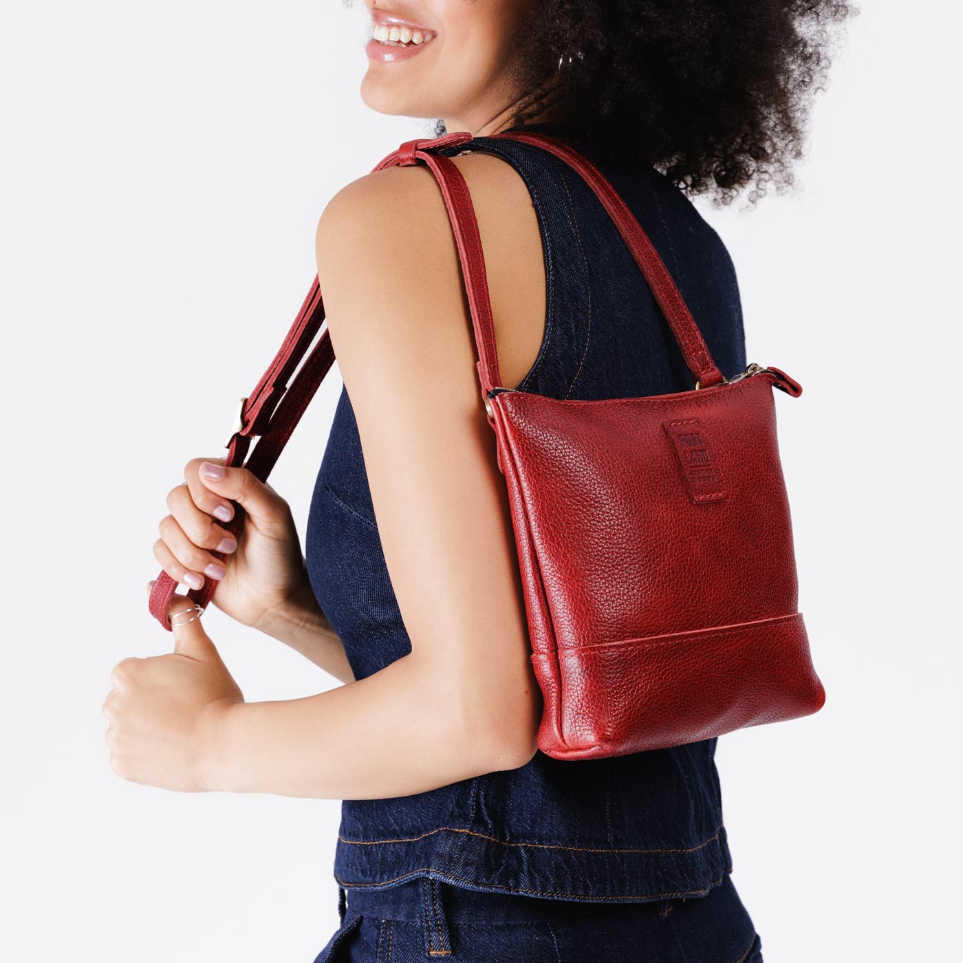 Chili Red | Model wearing small rectangular crossbody purse with top zipper and interior pocket