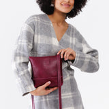 Orchid | Model wearing small rectangular crossbody purse with top zipper and interior pocket