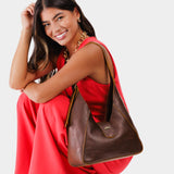 Coldbrew | Model wearing structured hobo shoulder bag with adjustable strap and magnetic closure