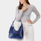 Cowboy Blue | Model wearing structured hobo shoulder bag with adjustable strap and magnetic closure