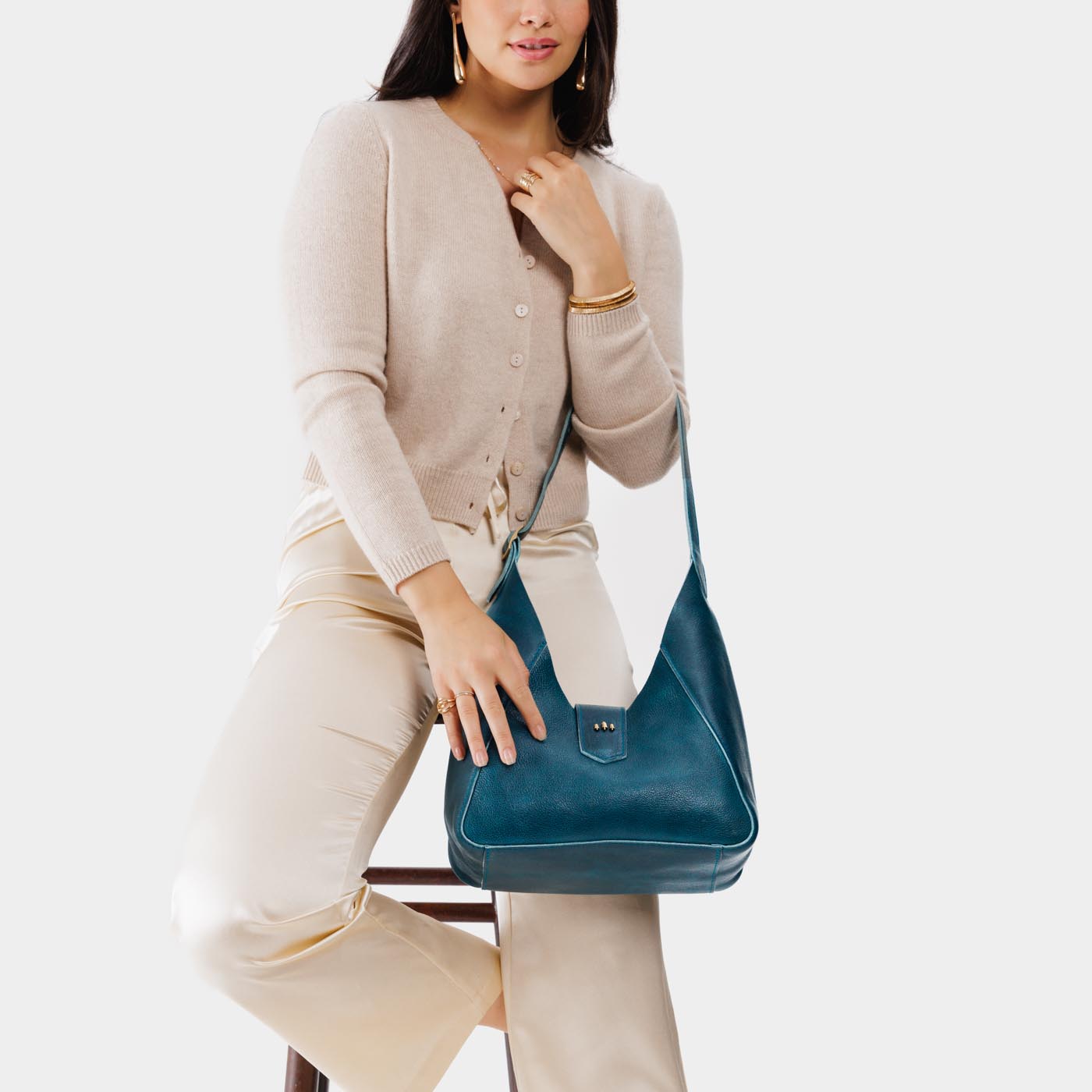 Lagoon | Model wearing structured hobo shoulder bag with adjustable strap and magnetic closure