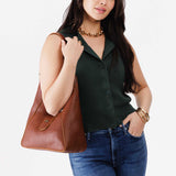 Nutmeg | Model wearing structured hobo shoulder bag with adjustable strap and magnetic closure