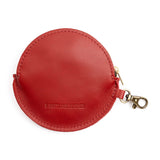 Wreath | Back of round holiday themed flat leather pouch with zipper and swivel lobster claw clasp