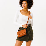 Honey Mini | Model Wearing Small Leather Crossbody Bag with Magnetic Messenger Bag Closure