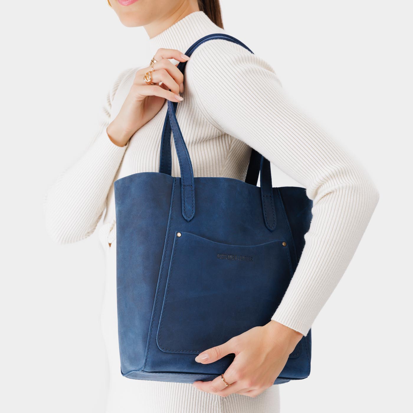 Deep Water*Large | Model holding dual shoulder strap tote bag with an exterior pocket