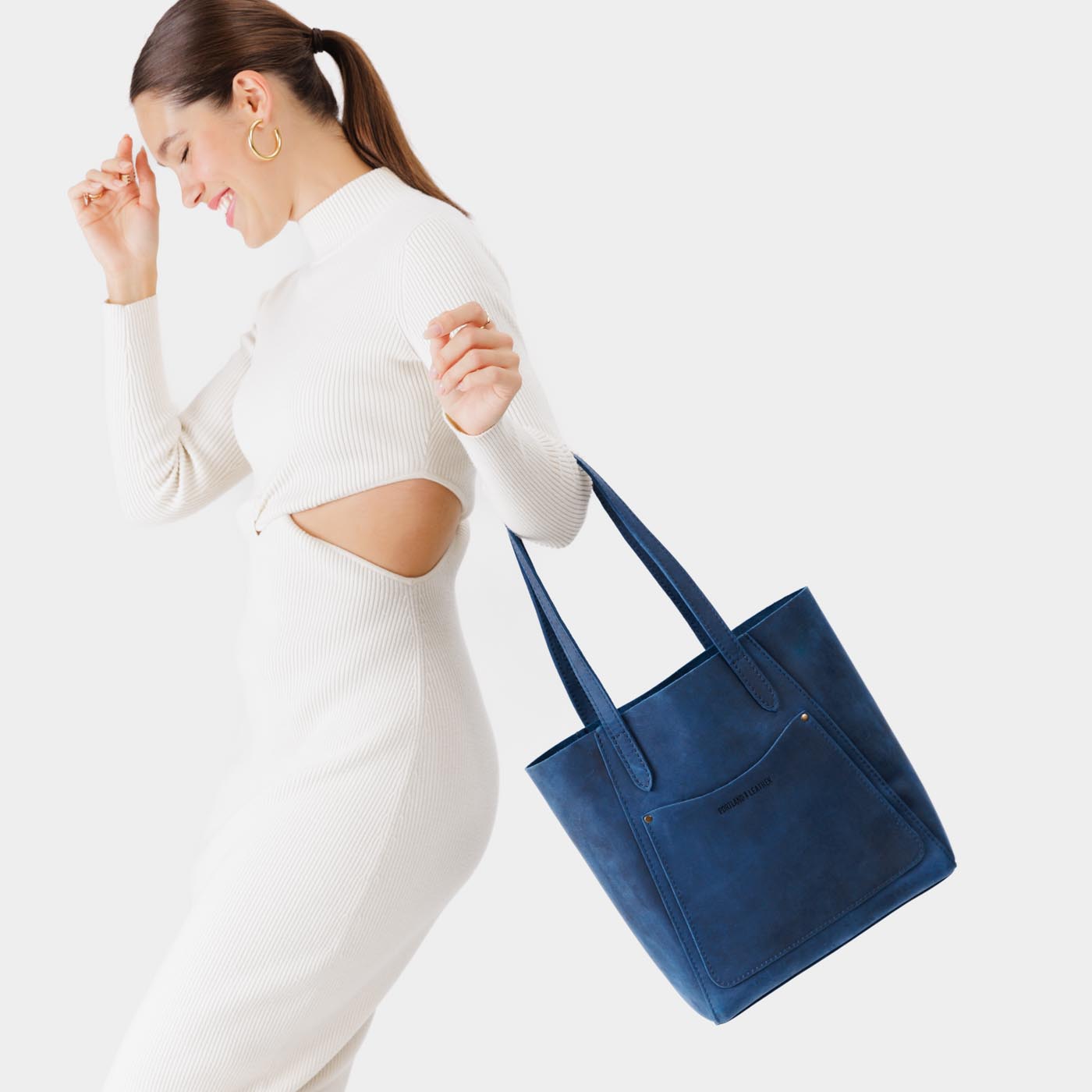 Deep Water*Large | Model holding dual shoulder strap tote bag with an exterior pocket