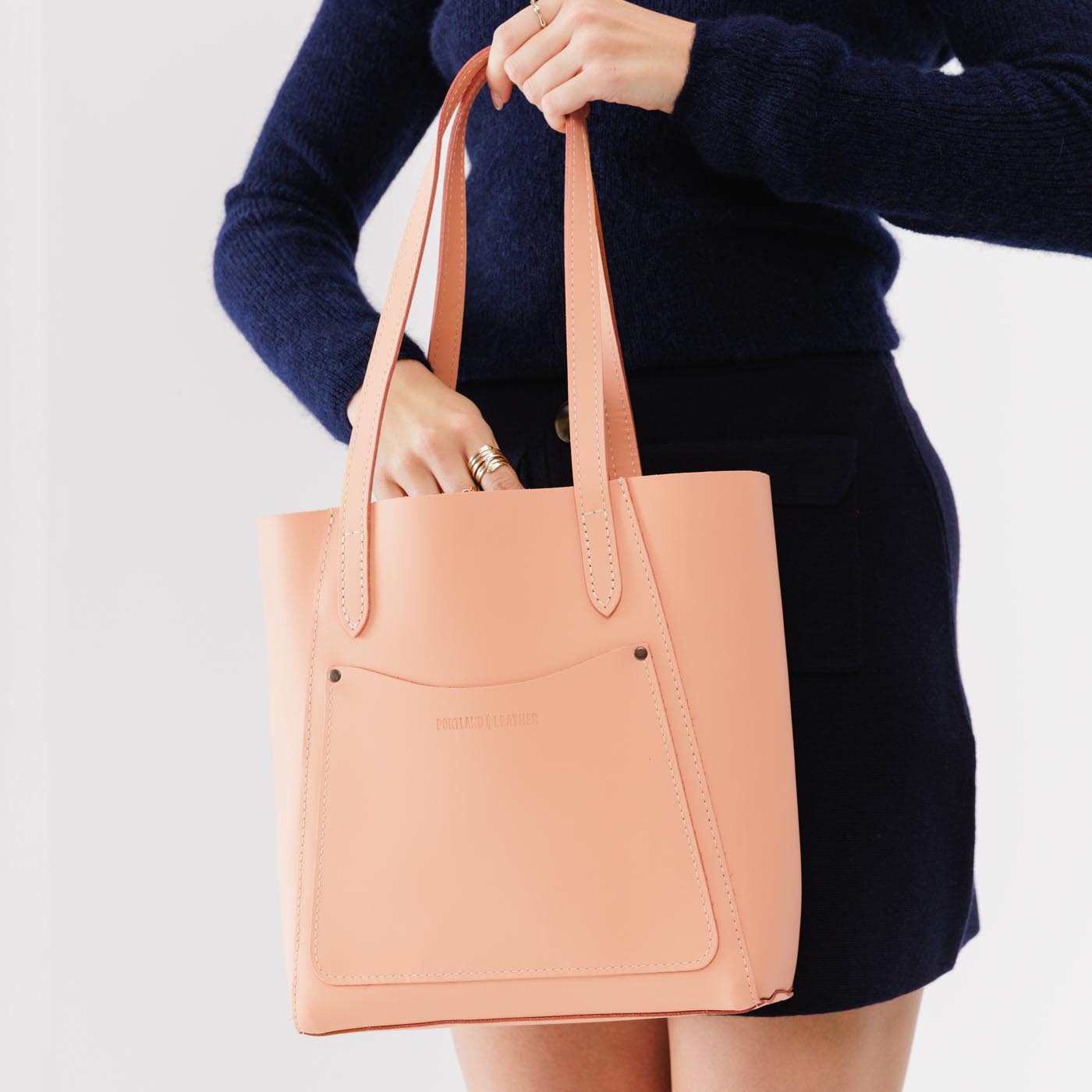 Mamey*Large | Model holding dual shoulder strap tote bag with an exterior pocket