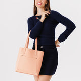 Mamey Large | Model holding dual shoulder strap tote bag with an exterior pocket