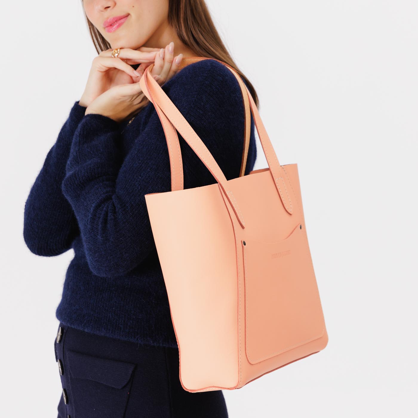 Mamey*Large | Model holding dual shoulder strap tote bag with an exterior pocket