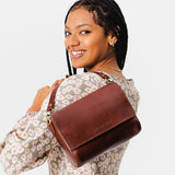 Cognac Medium | Model Holding Leather Crossbody Bag with Magnetic Messenger Bag Closure