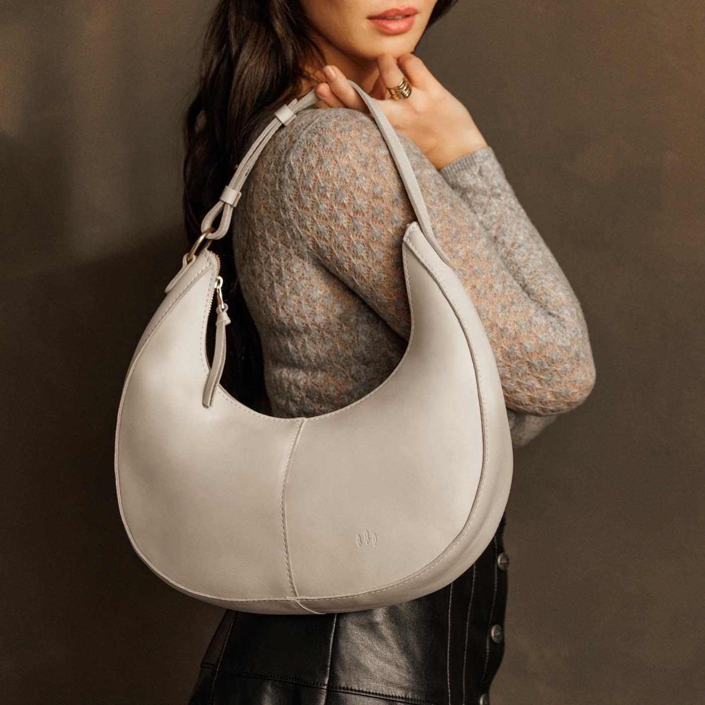 Bone*Large | Crescent shaped shoulder bag with zipper closure and adjustable strap