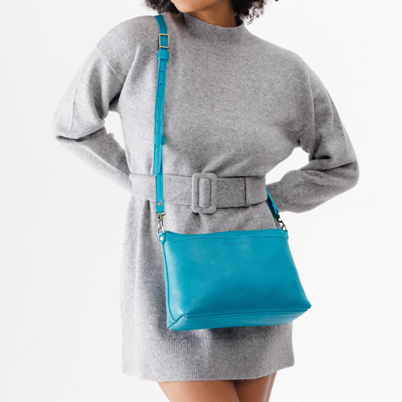 Baja | Model holding midsize zip top crossbody bag with detachable strap