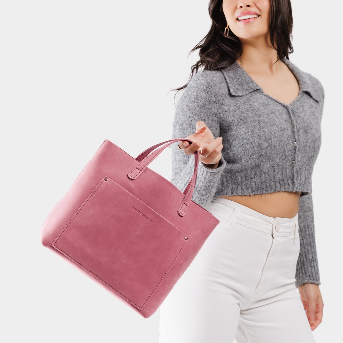 Foxglove*Classic | Model holding midsize crossbody tote with handles and a pocket