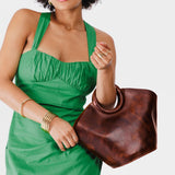 Lava Large | Model holding structured leather hand bag with circular handles