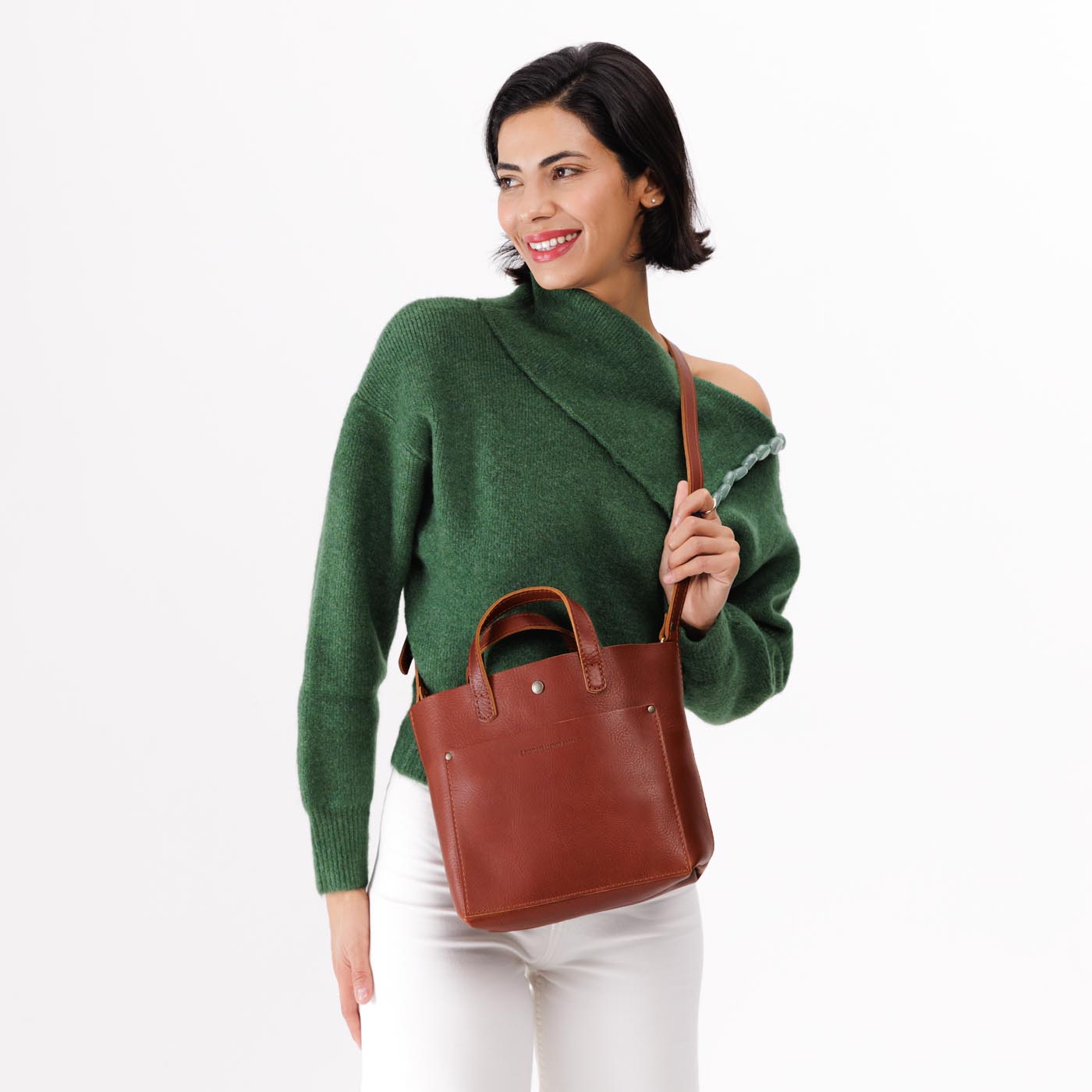 Chestnut*Classic | Model holding crossbody tote bag with snap closure and front pocket