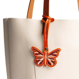 Koi | Embroidered butterfly tassel accessory on a bag