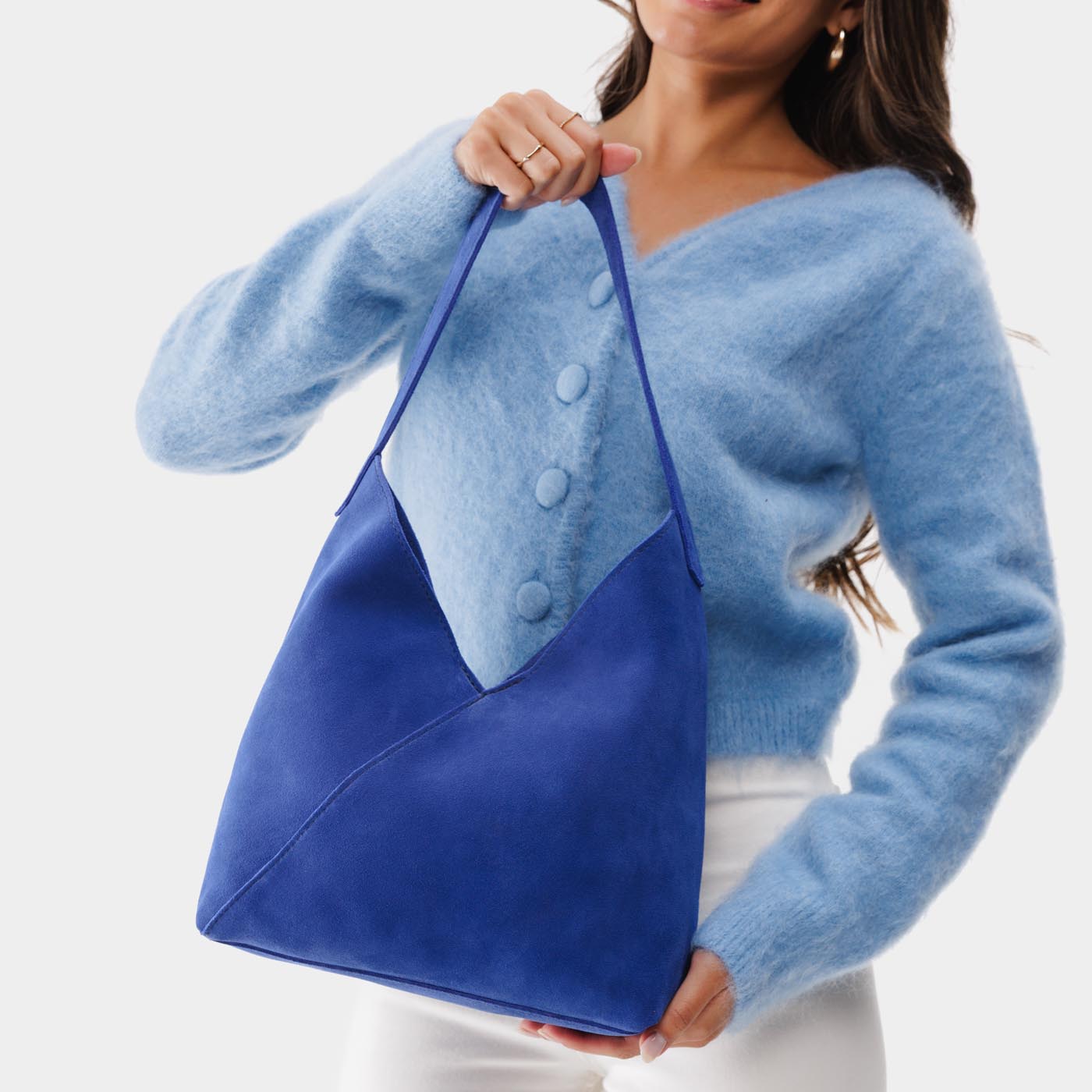 Joni Blue*Large | Model holding mid-size shoulder bag with magnetic snap closure