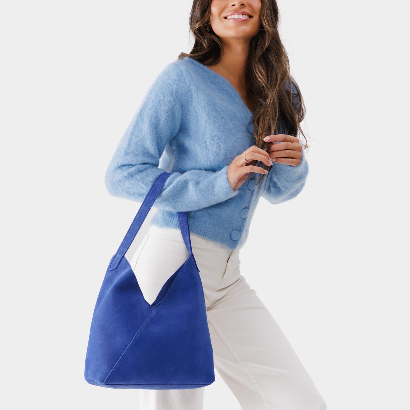 Joni Blue*Large | Model wearing mid-size shoulder bag with magnetic snap closure