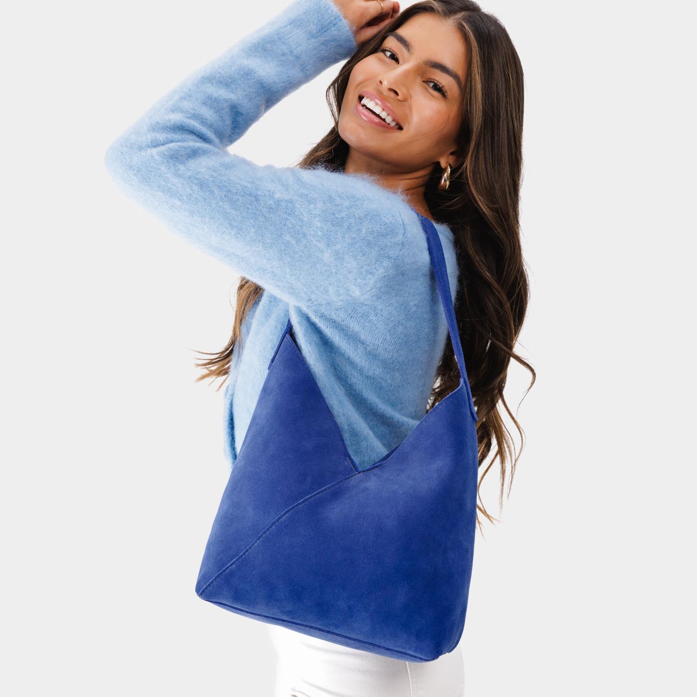 Joni Blue*Large | Model wearing mid-size shoulder bag with magnetic snap closure