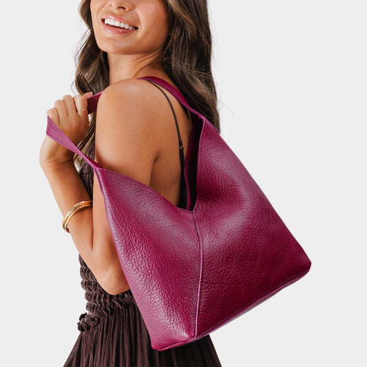 Orchid*Large | Model wearing mid-size shoulder bag with magnetic snap closure